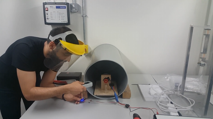 The craft's white duct body being worked on at the bench during the build.